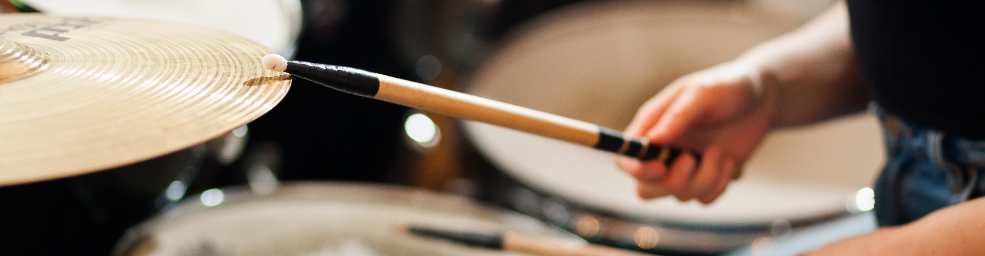 The drummer plays the drums.